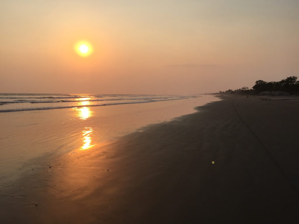 Sunset over the beach while surfing in Nicaragua