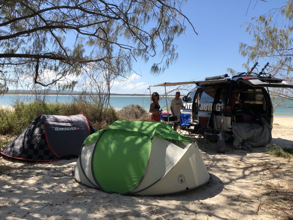 Camping tents set up on a sandy beach during a safari in Australia