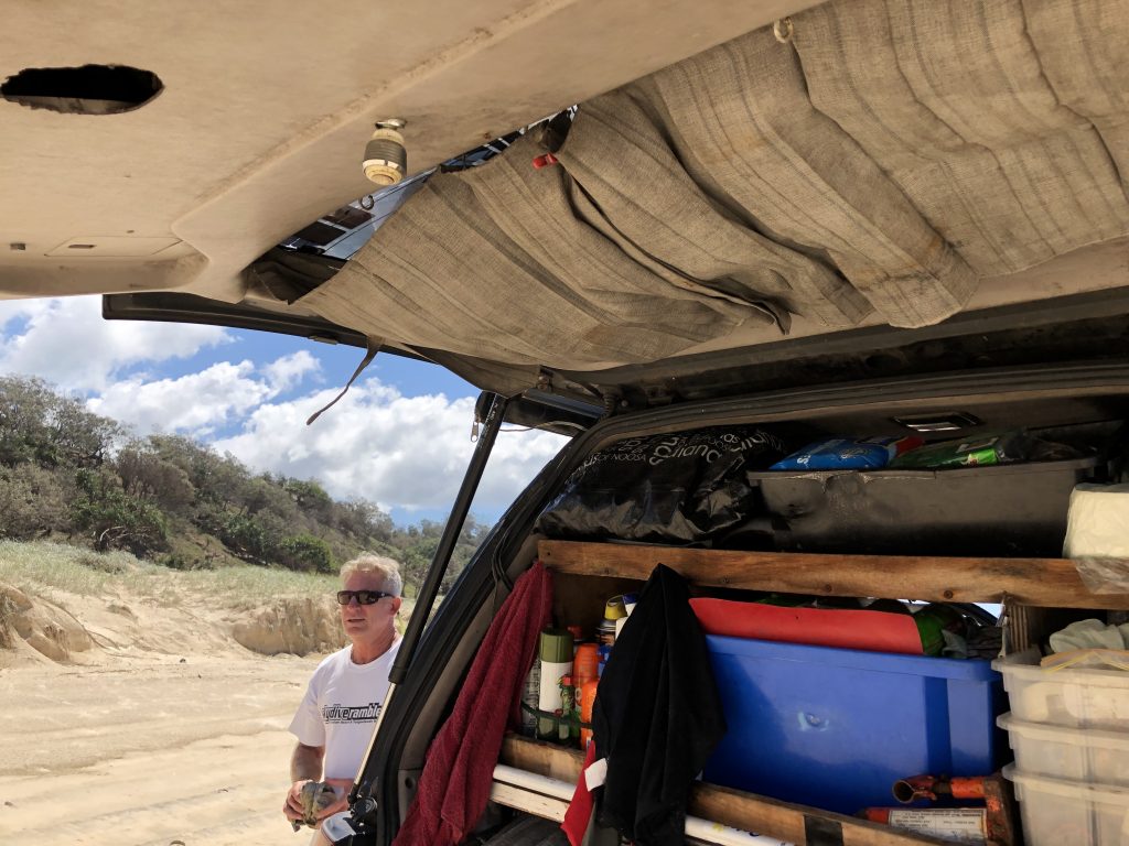 Brian set up a hot water shower with a curtain off the back of his vehicle hatch
