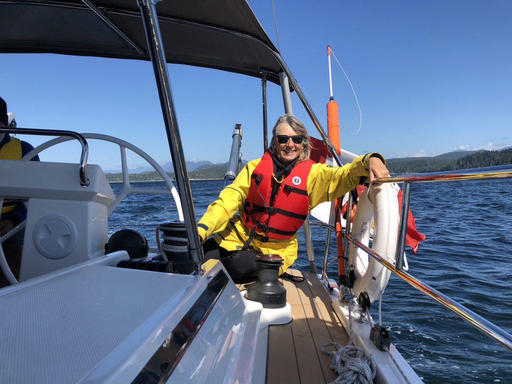 Mary at the helm, sailing in Desolation Sound