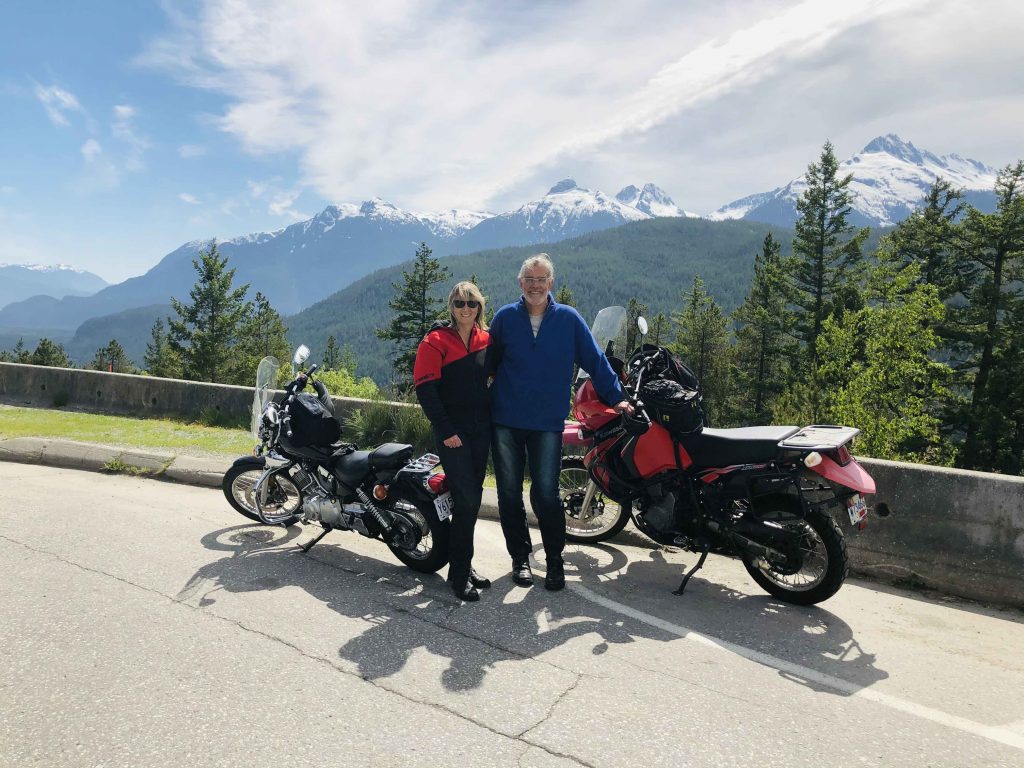 Mary and Chris standing beside their rented motorbike on the Sea to Sky Highway from Vancouver to Whistler