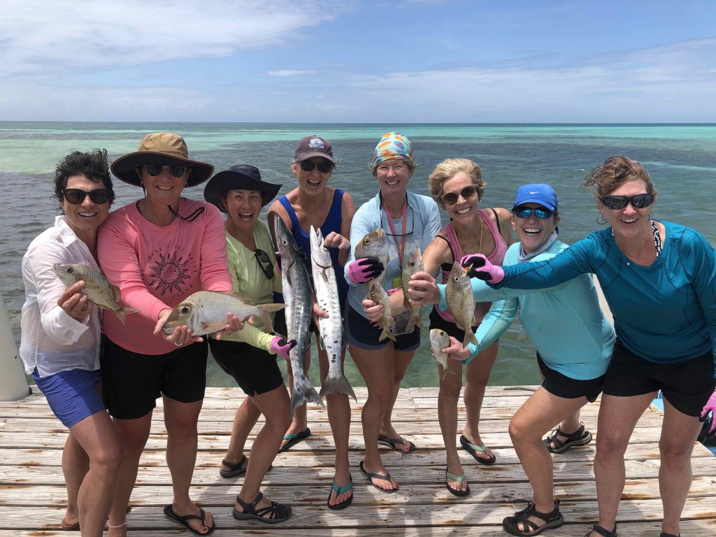 Mary and her friends holding their caught fish