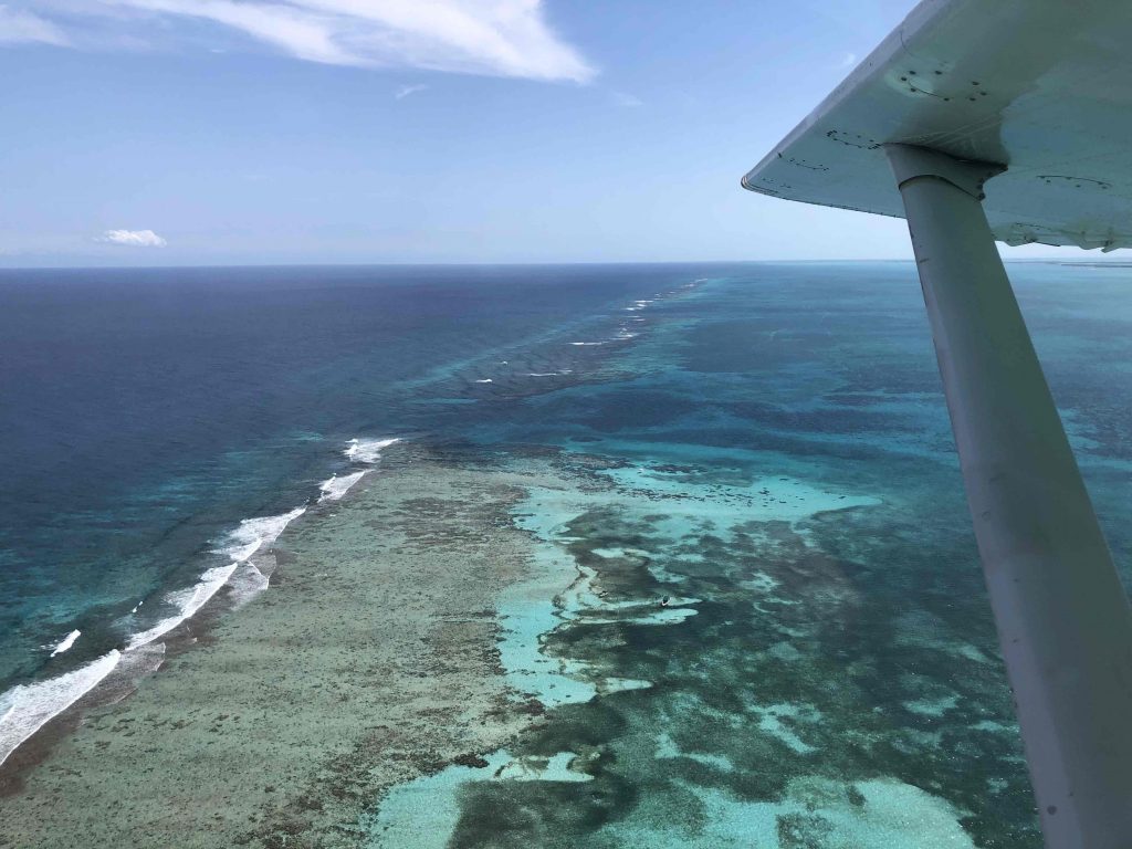 Aerial view—facts about the Great Blue Hole: nearly circular sinkhole inside Lighthouse Reef Atoll, Belize.