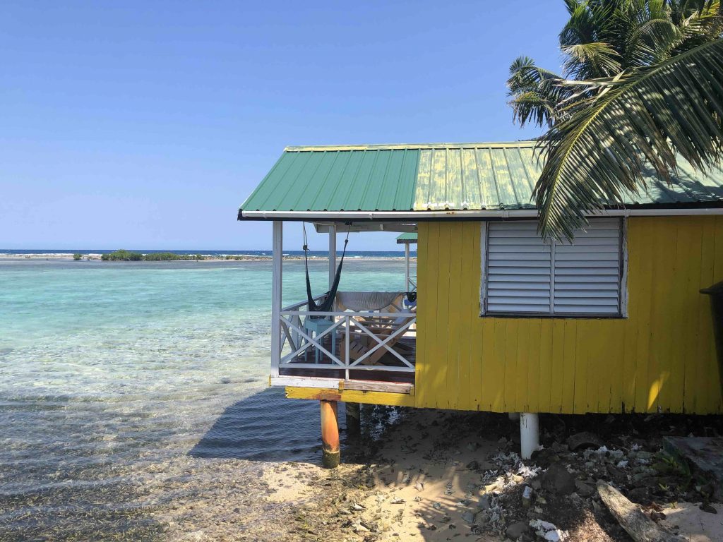 a yellow cabin at Tobacco Caye