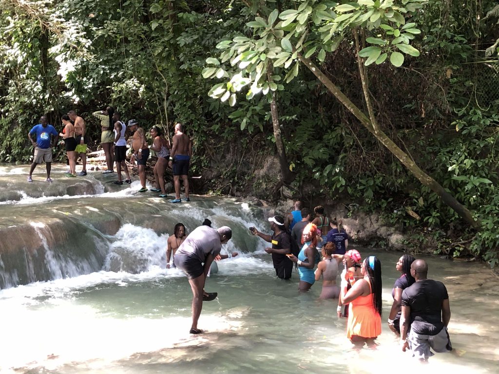 Group of tourists with a guide at Dunn’s River Falls
