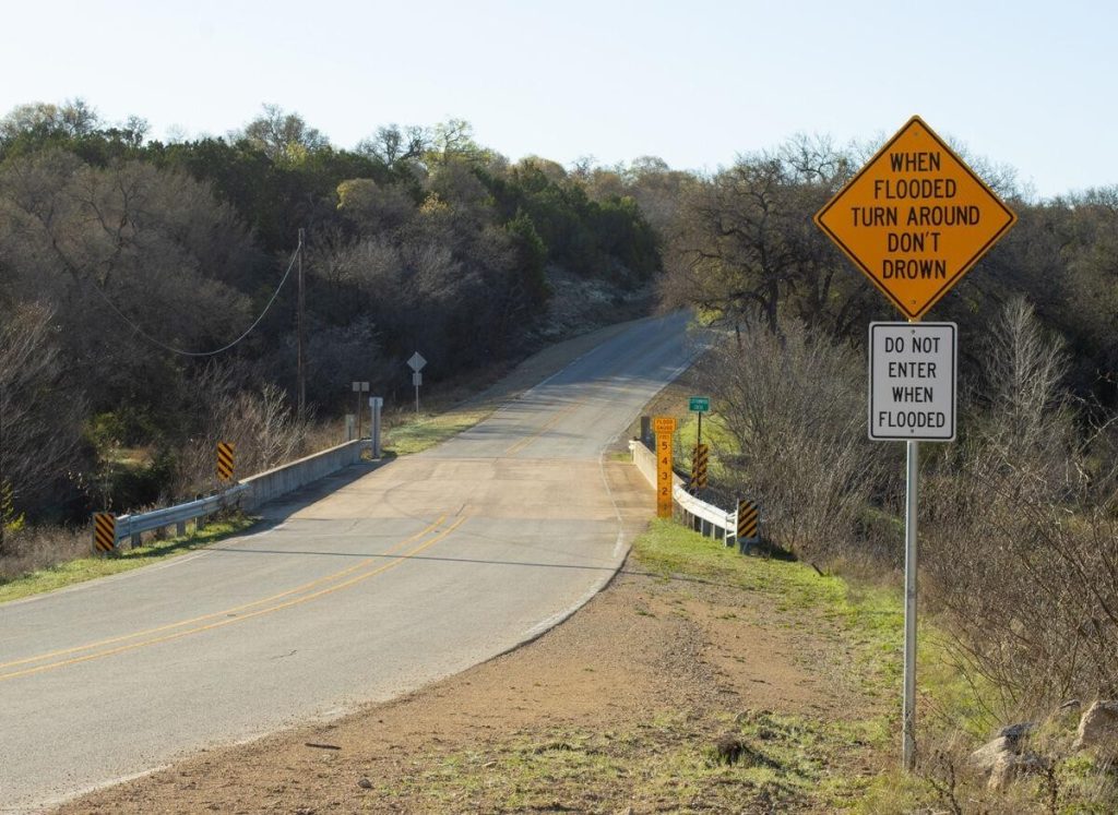 When Flooded Turn Around Don’t Down road sign