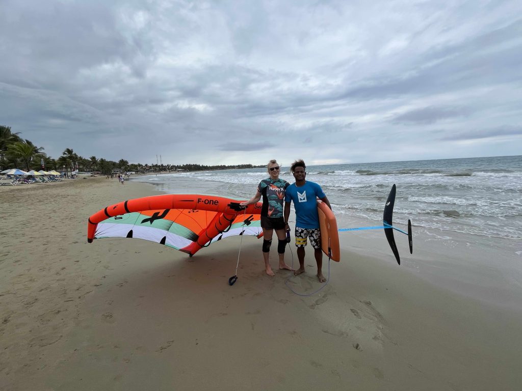 Mary Charlson with her instructor on the beach in Cabarete while learning to wing foil